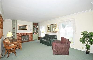 Living RoomGas Started fireplace is flanked by painted built-in bookcases