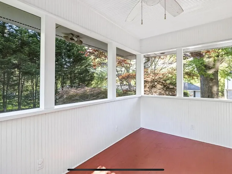 Screened in back porch overlooking the back patio and back yard