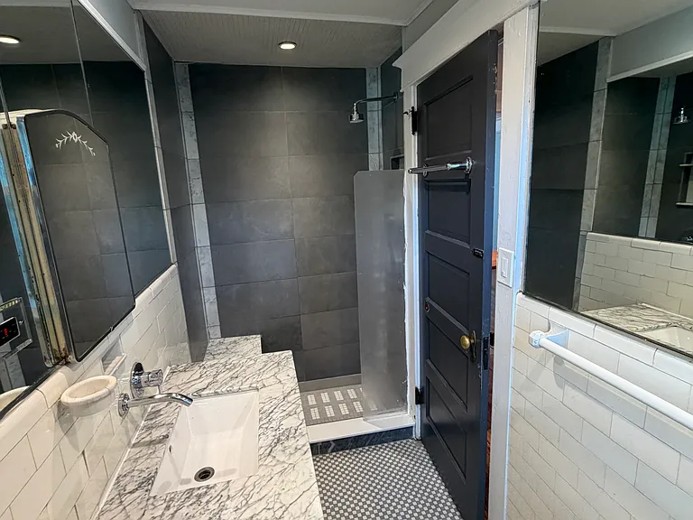 Bathroom with vintage details and walk-in shower.