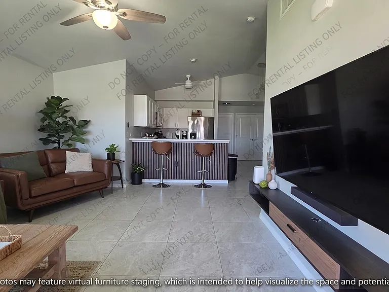 Spacious and inviting open-concept living area featuring sleek, easy-maintenance tile flooring throughout and abundant natural light. This versatile space is perfect for relaxing or entertaining and offers a bright, modern backdrop for your personal style