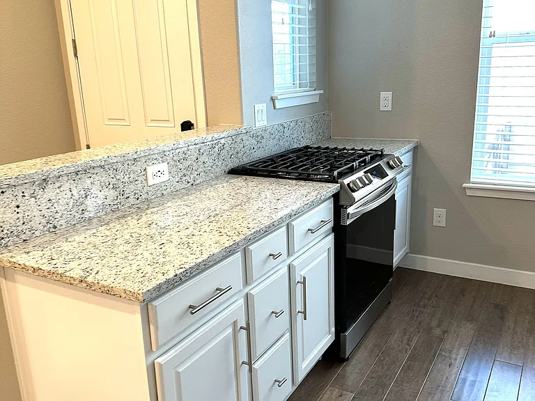 The kitchen features windows that provide abundant natural light, creating a bright and welcoming space.