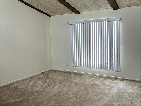 Living room with high beam ceiling