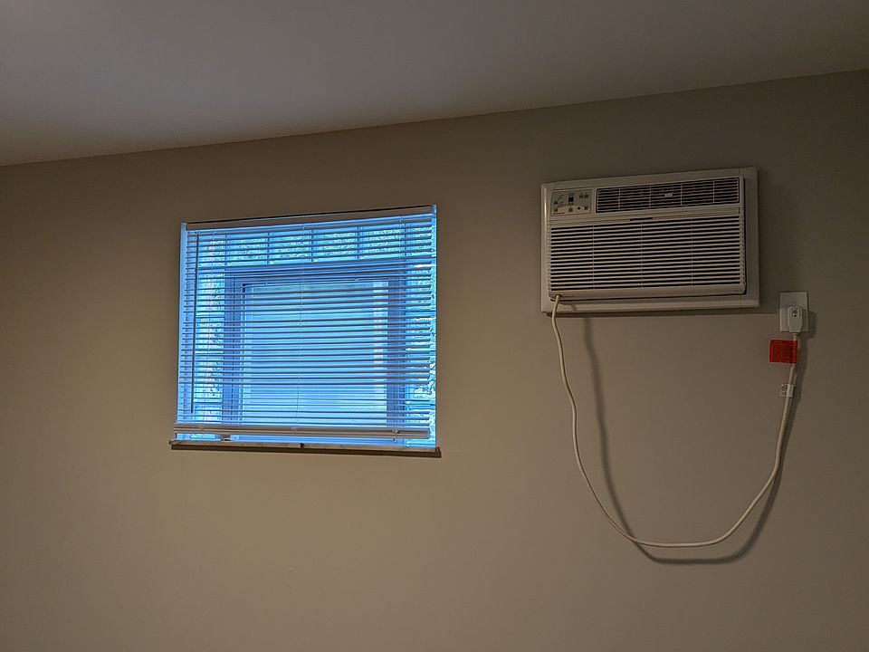 Bedroom with wall Ac unit