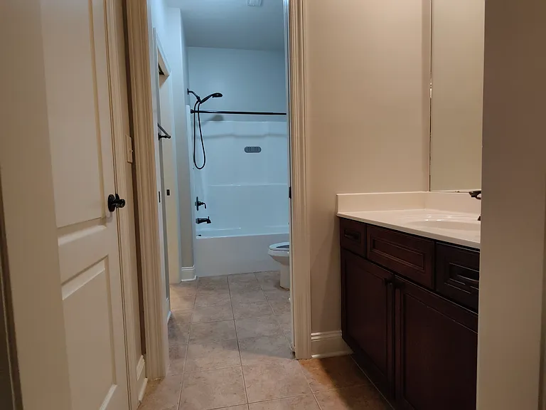 Front side and back side bedrooms share the same shower, but separate vanities.