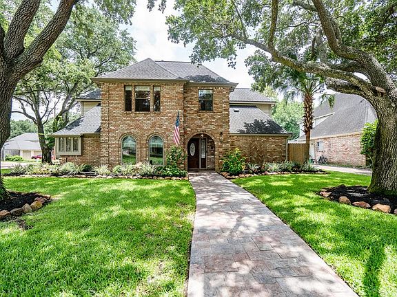 The home is set within lovely lawn and mature planting beds.