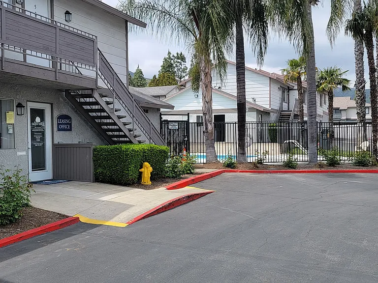 Leasing office and gated pool at Grand Oaks Apartments in Lake Elsinore, California.