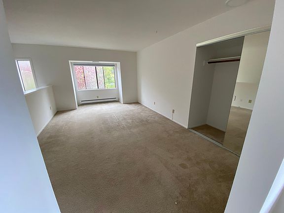 large bedroom space with mirrored closet