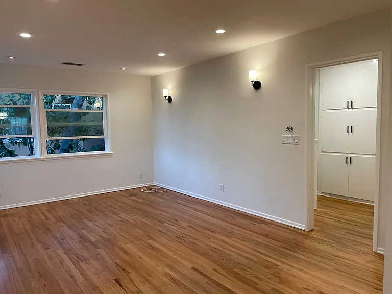 Living room leading to hallway to bedrooms and bathroom