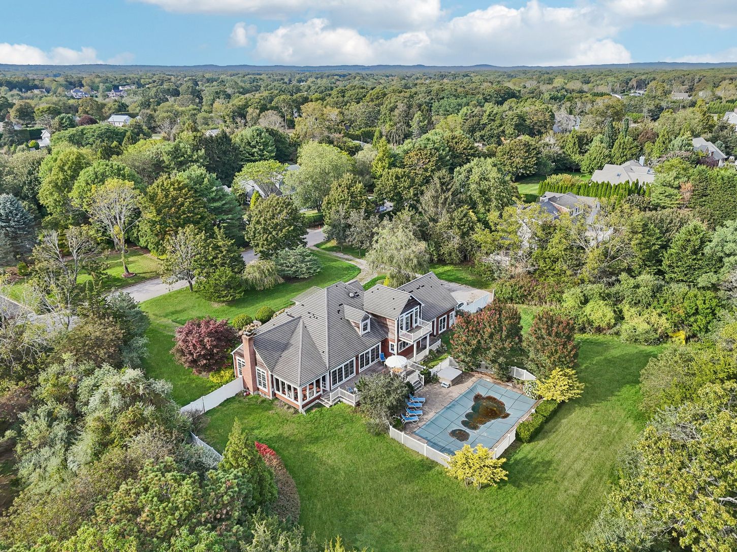 From the rear, the home reveals its inviting charm—complete with a fenced backyard.