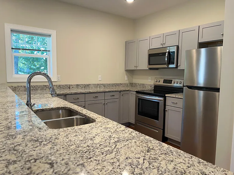 The large kitchen has long granite countertops, a pantry and abundant cabinetry along with a full suite of appliances.
