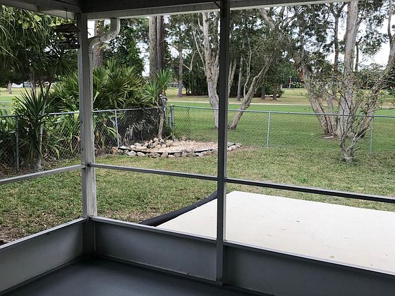 closed in porch, concrete patio and gated yard