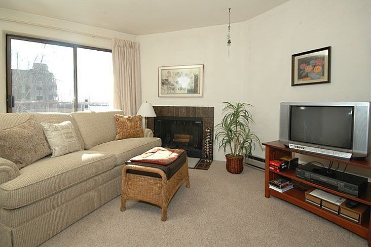 spacious living room with wood burning fire place
