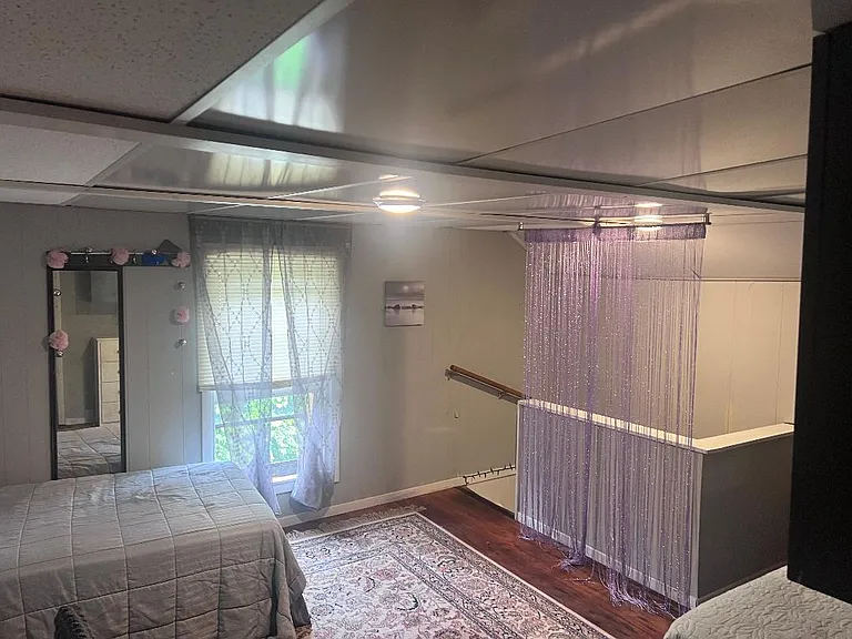 2nd floor bedroom with 2 twin beds, dressers and small work area