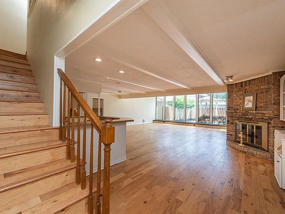 Spacious living area with beautiful hardwoods, built-ins, a fire place, a wet bar and TONS of possibilities.