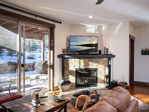 View of walkout patio - cushioned loveseat, chair, ottoman and Chaise lounge. Gas Grill.