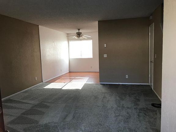 Living room and hardwood floor dining with freshly cleaned carpet and new coat of painting