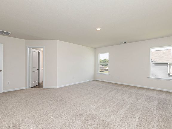 The spacious master bedroom has direct access to a bathroom with two walk in closets