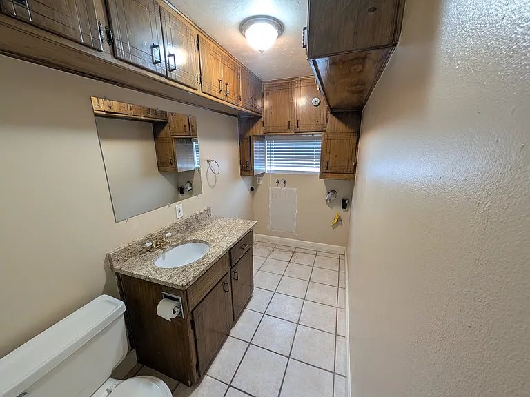 Half-bath with laundry hookups and extra cabinets