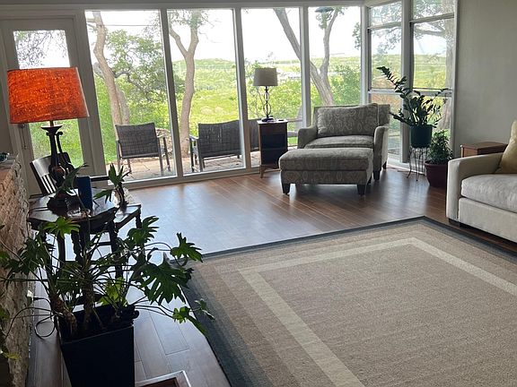 Living room. Door to outdoor patio. Fabulous views of Barton Creek Greenbelt and the City