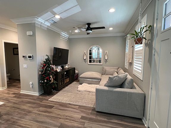 TV area with neutral paint and beautiful custom wood shutters.