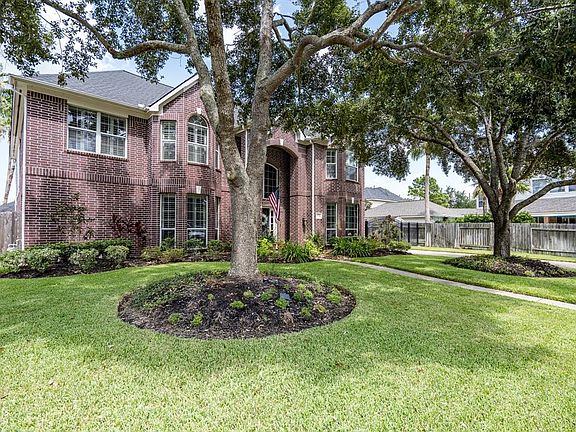 A stately 2-story traditional style home with mature trees and lush landscaping offers great curb appeal!