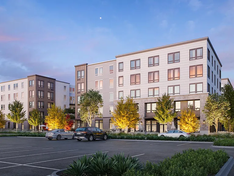 Evening light highlights the inviting design of Modera Bridle Trails, creating a warm and welcoming community atmosphere.