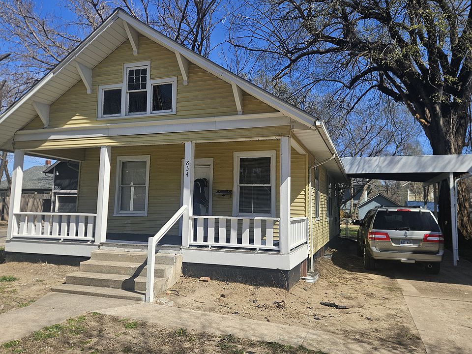 Big covered front porch and high carport. Hope you don't mind a yellow house walking distance to Riverside Park.
