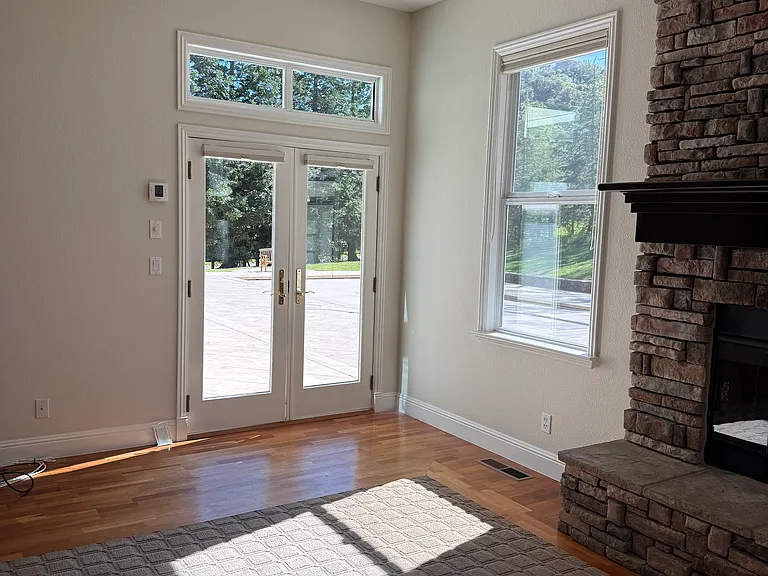 Three sets of french doors lead to backyard pool and outdoor kitchen (family room, living/dining room, and primary bedroom access to backyard)