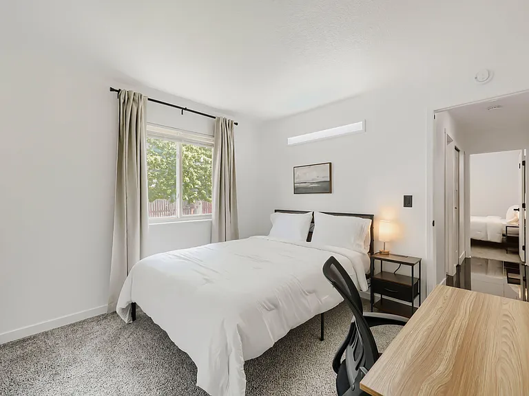 Cozy room with Queen bed, nightstand and lamp with USB, desk set up. Bed linens, towel, shower caddy and blackout curtains.