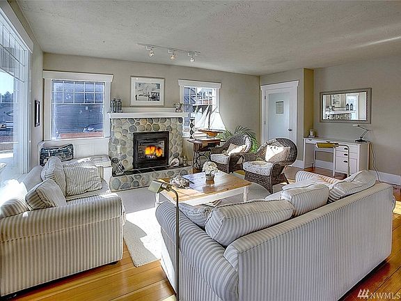 Great room with bay view, river rock gas fireplace, fir floors and hand plastered walls. 
