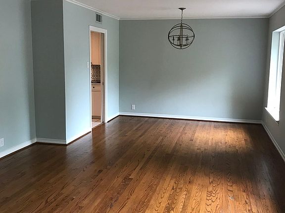 spacious open floor plan dining and living space with hardwo