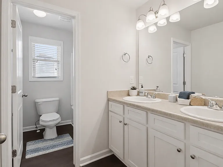 Secondary bathroom with double vanity and shower/tub combo