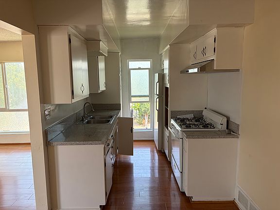 Kitchen with stove and refrigerator
