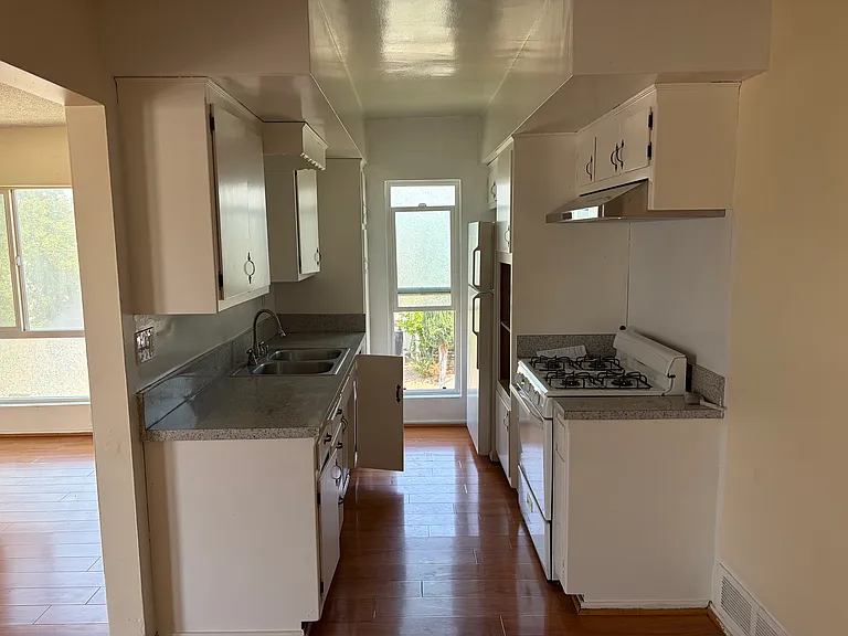 Kitchen with stove and refrigerator