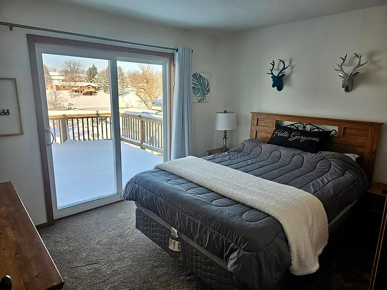 2nd Bedroom has it's own beautiful lake view with walk out patio doors heading down to the lake.
