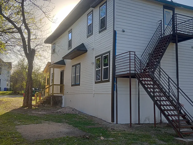 Rear and side showing secondary exits for both units. All new siding, new windows, and new porch.