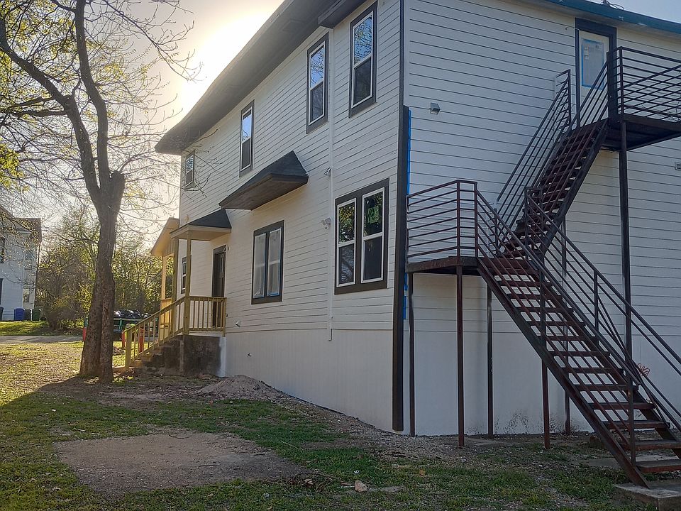 Rear and side showing secondary exits for both units. All new siding, new windows, and new porch.