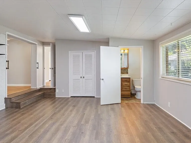 Large family room with half bath and door to backyard.