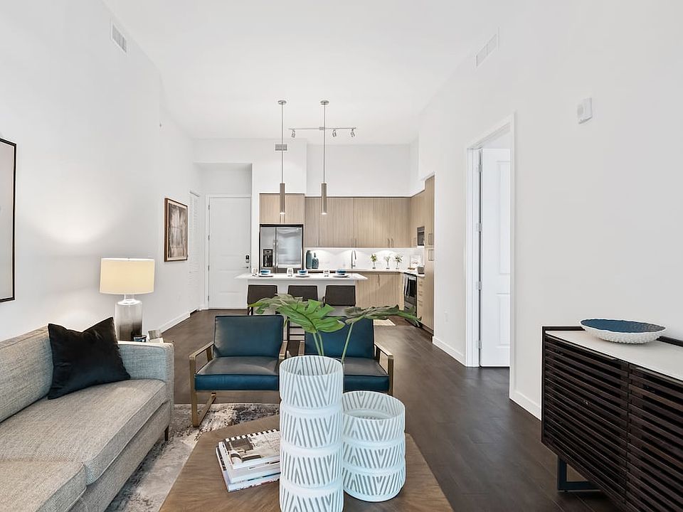 Kitchen, living, and dining areas with hard-surface vinyl plank flooring