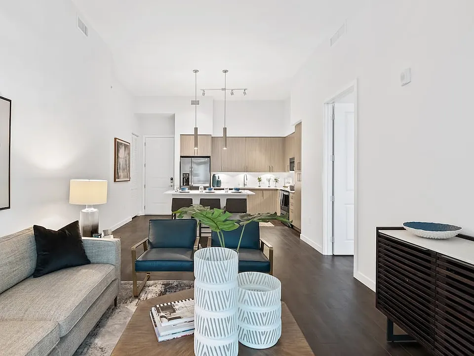 Kitchen, living, and dining areas with hard-surface vinyl plank flooring