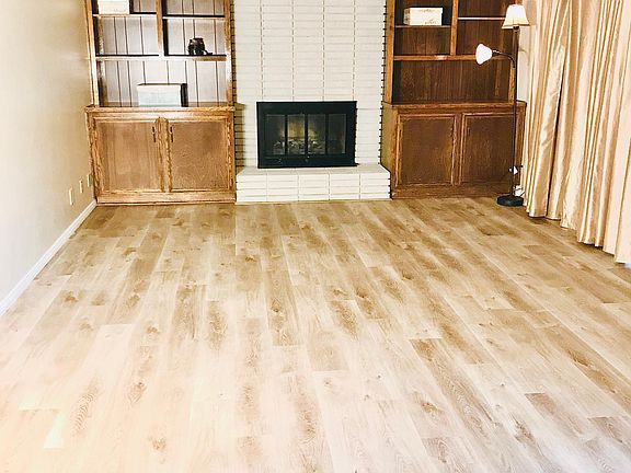 From the front entrance, you walk into the main living room area overlooking the pool and patio through the french doors.