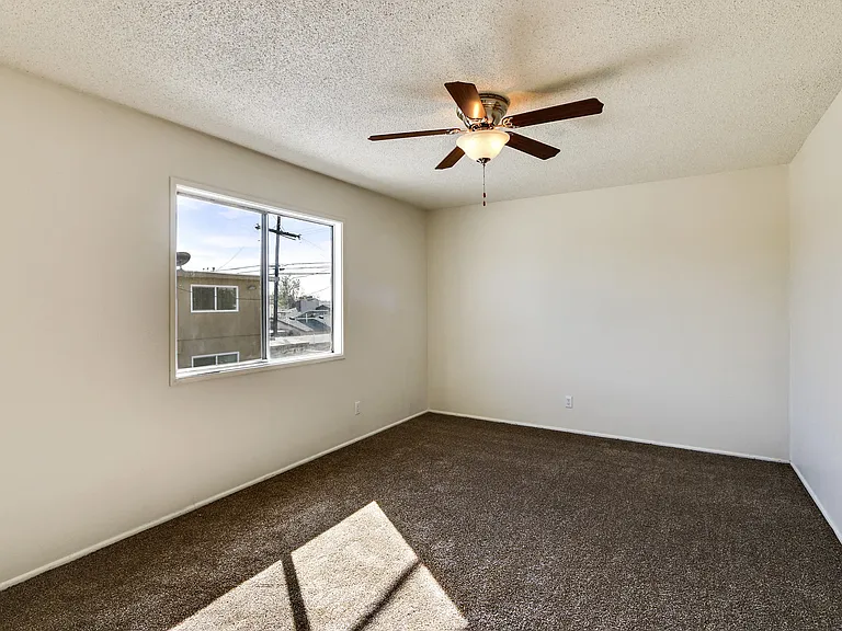 Bedroom with ceiling fan and carpeted floors