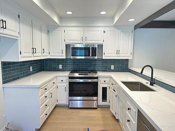 Kitchen undergoing remodel with all new appliances, counters and backsplash
