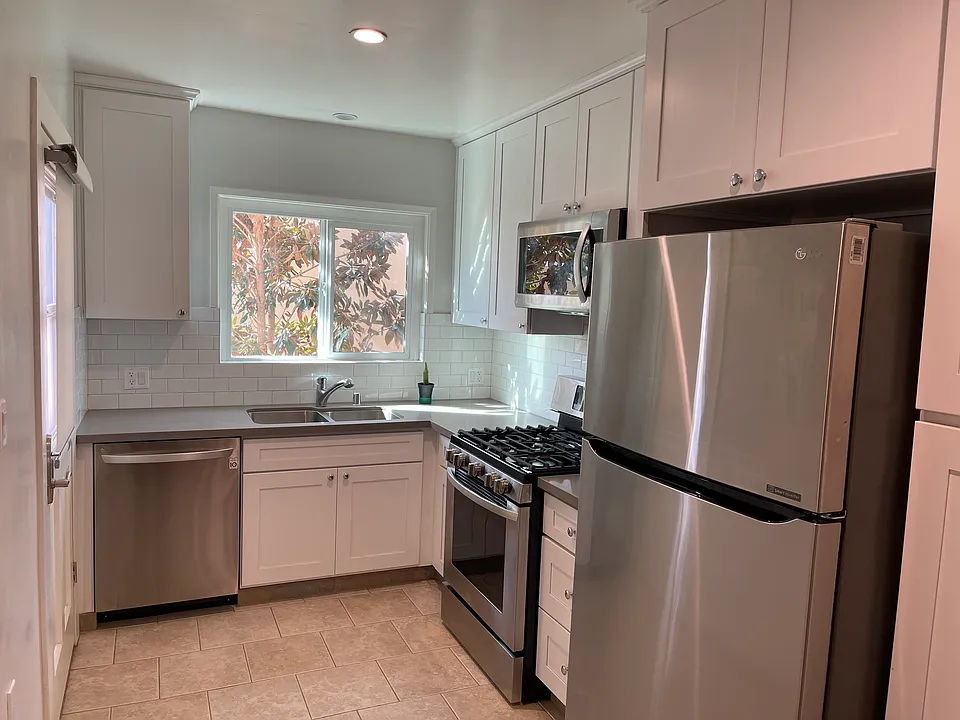 10716 kitchen with 4 ss appliances- gas stove, microwave, refrigerator & stove. Back door entrance too!