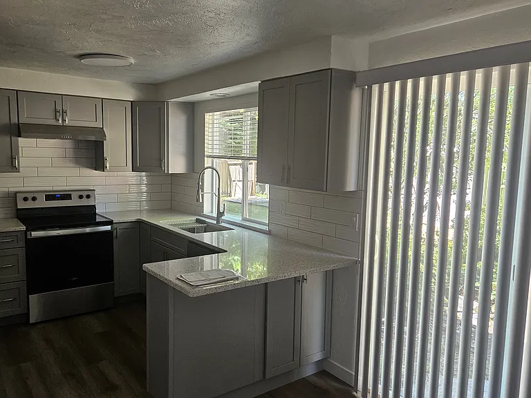 Kitchen w slider to backyard