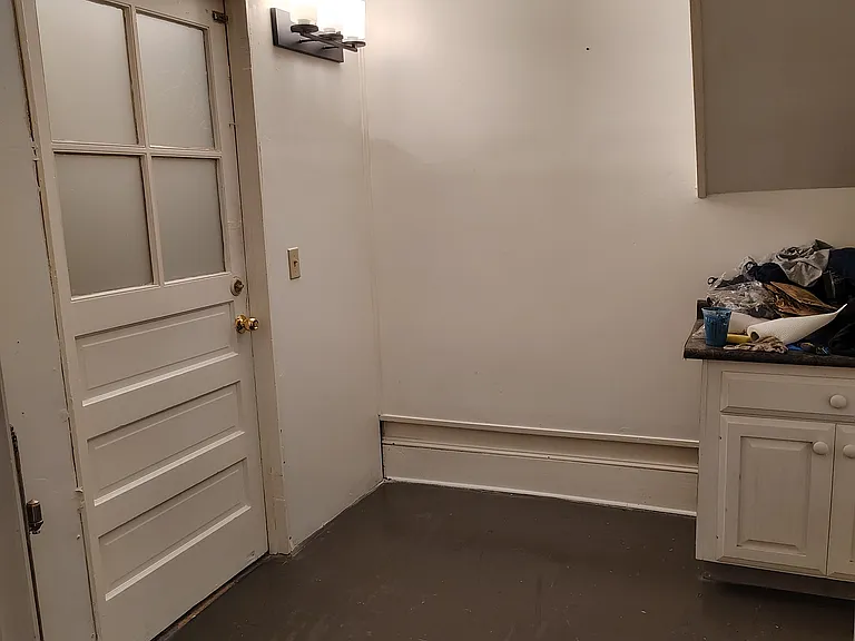 Front entry room, with cabinet and room for coat racks. Looking East from Living room door