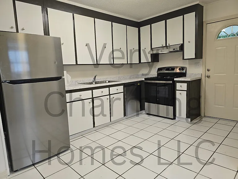 The kitchen is in the rear half and has a rear exit. All appliances you see are new including the dishwasher.