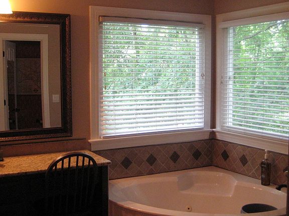 new master bath w/ tile floor, tile shower, jacuzzi tub, granite vanities