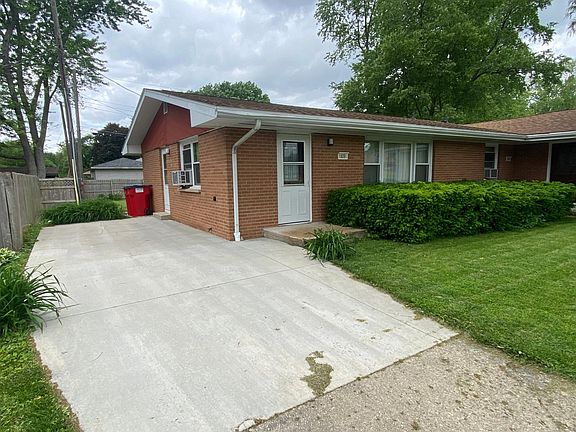 This portion of the driveway was replaced a few years ago. There are lillies planted at three different areas surrounding the driveway and the downspout drains under the concrete on the south side.
