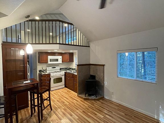 Living room, dining space with table and 2 chairs ( if you want to use them) and cozy fireplace. Ceilings fans in living and bedroom. Upper loft space for sleeping, office or storage. Mini split for air conditioning in living room too!